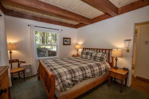 a bedroom with a bed and two lamps and a window at Hillhouse By Hauserman Rentals in Homewood