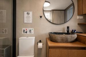 a bathroom with a sink and a mirror at Seaside Breeze Villa - Beachfront, Private Pool, BBQ in Agia Pelagia +24 photos