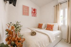a white bedroom with a bed and a window at Seaside Breeze Villa - Beachfront, Private Pool, BBQ in Agia Pelagia