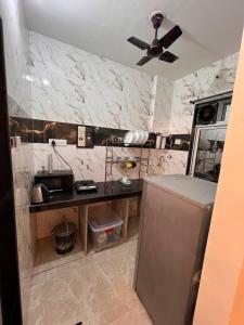 a kitchen with a counter and a refrigerator at Sugar Waves in Navi Mumbai +32 photos