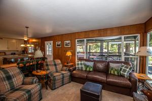 a living room with a couch and chairs and a kitchen at Holland By Hauserman Rentals in Homewood