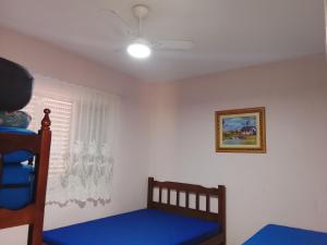a bedroom with two bunk beds and a window at Casa da vovó Marta in Itanhaém +18 photos