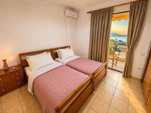 a bedroom with a bed and a balcony at Lana's Apartment in Sarandë