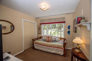 a bedroom with a bed and a window at Holland By Hauserman Rentals in Homewood