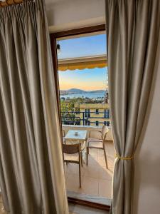 a room with a window with a table and a view at Lana's Apartment in Sarandë