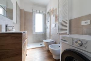 a white bathroom with a toilet and a sink at Casa MaMi in Gatteo a Mare +29 photos