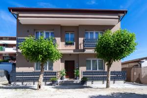 a house with two trees in front of it at Casa MaMi in Gatteo a Mare