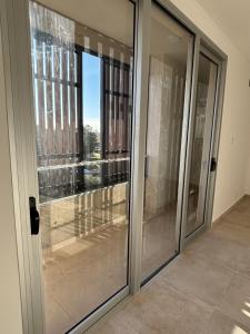 a glass door with a view of a building at Moras Urban in Esperanza