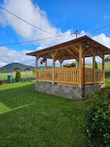 a wooden gazebo in a yard at Apartmani NINA Zlatar in Nova Varoš