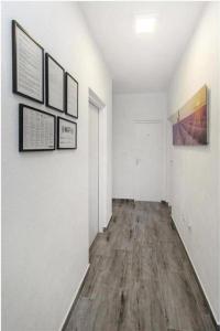 an empty hallway with white walls and wood floors at Potkova in Lađevci +62 photos