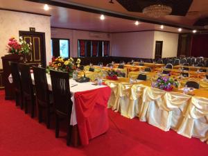 a banquet hall with tables and chairs with flowers on them at E-Outfitting Vang Thong Hotel in Luang Prabang +32 photos