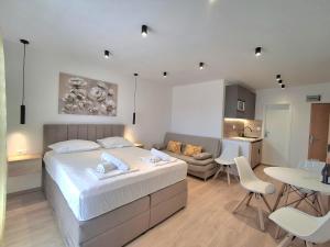 a bedroom with a bed and a living room at Villa Rossa 2 in Tučepi
