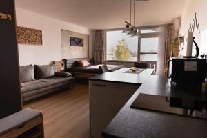 a kitchen and living room with a couch and a table at MountainLOVE in Strobl