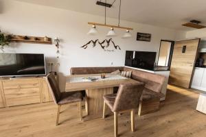 a kitchen with a table and chairs in a room at MountainLOVE in Strobl +24 photos