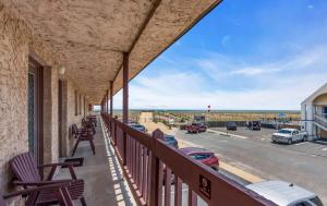 a balcony with chairs and a view of the ocean at Windswept Motel in Point Pleasant Beach
