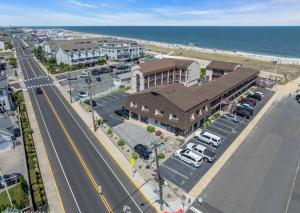 an aerial view of a town with a building and the ocean at Windswept Motel in Point Pleasant Beach