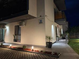a building with candles in a courtyard at night at MIKA Studios in Eforie Nord