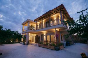 a large house with a balcony on the side of it at Maresol Villa in Nea Kallikrateia