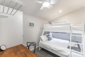 a bedroom with two bunk beds and a table at Hillhouse in Myrtleford