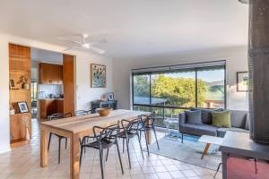a kitchen and living room with a table and chairs at Hillhouse in Myrtleford