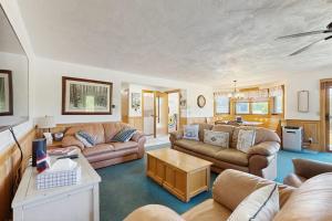 a living room with couches and a table at Christmas Mountain Retreat in Bartlett