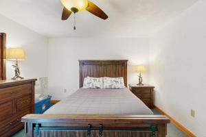 a bedroom with a bed and a ceiling fan at Christmas Mountain Retreat in Bartlett