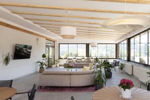 a living room with a couch and tables and windows at CASA ENCIAN in Colibiţa