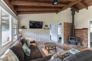 a living room with a couch and a fireplace at Gangurru in Myrtleford