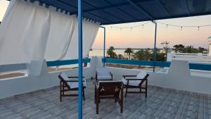 a patio with chairs and a table on a roof at Villa Aura in Ouled Yaneg