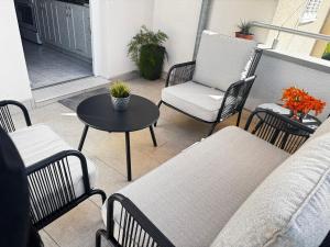 a patio with chairs and a table and a chair at Sunset Hill Apartments in Brodarica +31 photos