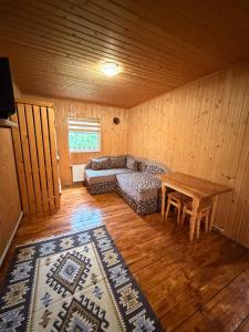 a living room with a couch and a table at Садиба у Оксанки in Vorokhta
