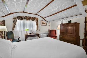 a bedroom with a bed and a desk and chairs at Lamies Inn & The Old Salt Tavern in Hampton +71 photos