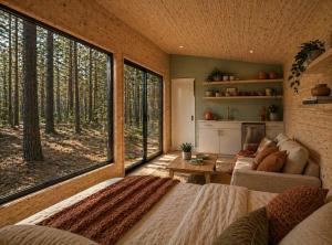 a living room with a large window in a house at Ponderosa Pines Resort in Parks