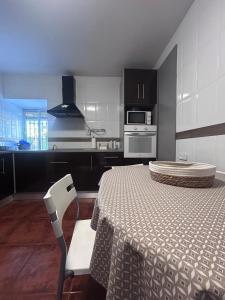 a kitchen with a table and a chair in a room at CASERIO LA SEVILLANA in Baeza