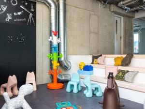 a room with many different types of toy animals at ibis Styles Delft City Centre in Delft