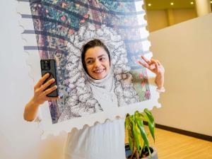 a woman taking a picture of herself with her cell phone at ibis Styles Sorocaba Santa Rosalia in Sorocaba
