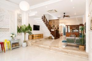 a living room with a staircase in a house at Casa de LYN Nha Trang in Nha Trang