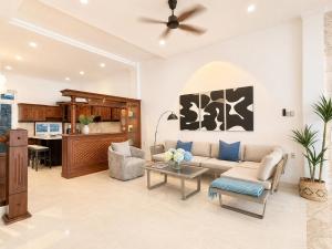 a living room with a couch and a table at Casa de LYN Nha Trang in Nha Trang