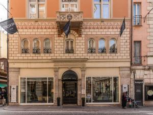 a building on a street with flags in front of it at Mercure Roma Centro Termini in Rome