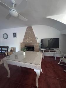 a living room with a table and a fireplace at CASERIO LA SEVILLANA in Baeza