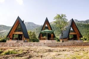 a log cabin with mountains in the background at Ujcevina Apartments in Donje Morakovo