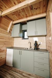 a kitchen in a log cabin with a sink at Ujcevina Apartments in Donje Morakovo +13 photos
