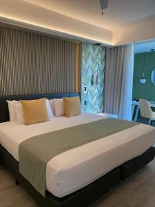 a bedroom with a large bed in a room at M- NET LUXURIOUS HOTEL KAGADi in Kagadi