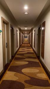 an empty hallway of a building with a long corridor at M- NET LUXURIOUS HOTEL KAGADi in Kagadi
