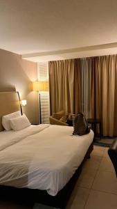 a hotel room with a bed with a bag on it at M- NET LUXURIOUS HOTEL KAGADi in Kagadi