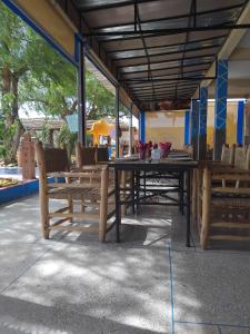 a table and chairs sitting under a pavilion at Gîte d'étape Imane Café ET Restaurant in Aït Amar