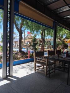 a picnic table and chairs in front of a playground at Gîte d'étape Imane Café ET Restaurant in Aït Amar