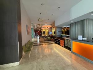a lobby with chairs and a bar in a building at The District Hotel in Panama City