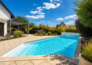 a swimming pool in the backyard of a house at Le Vogelgarten in Zellenberg