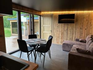 a living room with a table and chairs at Sodyba Anykščių raj. in Anykščiai